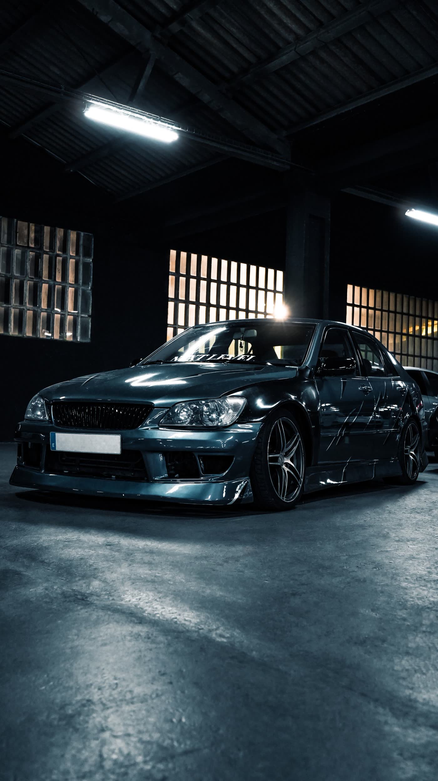 Glossy black sedan under studio lighting