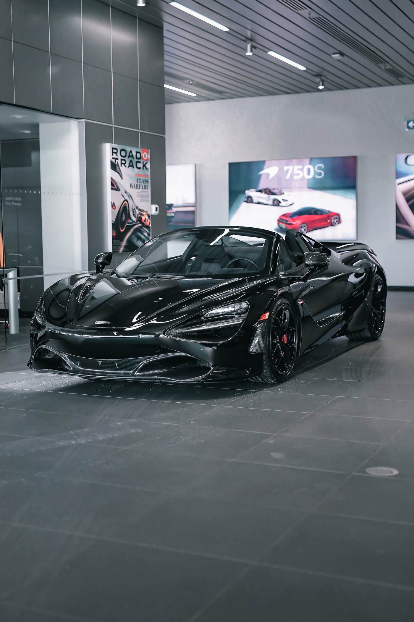Black convertible supercar with mirror gloss in showroom